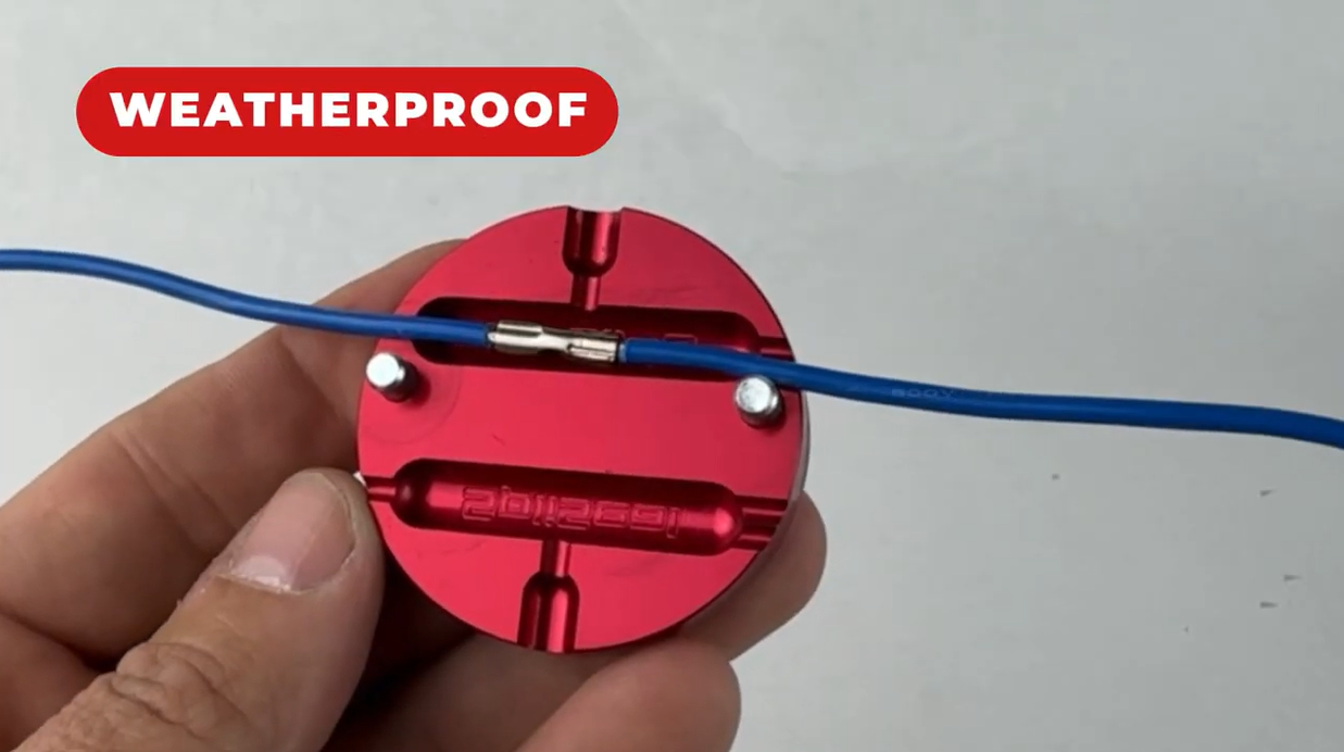 A real crimped wire splice sealed weatherproof inside the red SpliSeal mold