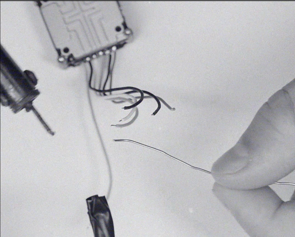 A frayed, damaged wiring harness with loose bare wires — a connection about to fail